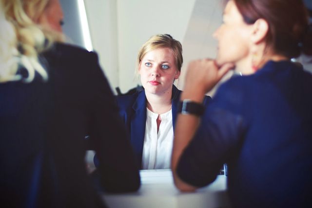 A woman in a job interview with two other women. 