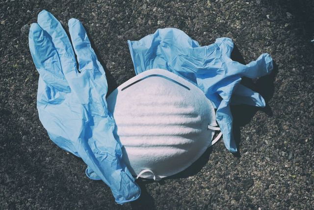 Disposable gloves and mask (PPE) symbolising the coronavirus and its effect on mining jobs.