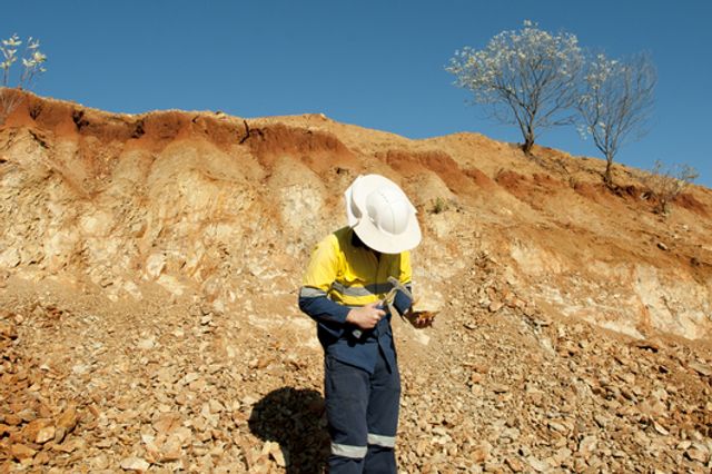 Geologist inspecting piece of rock