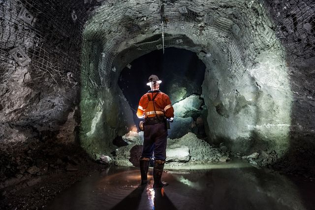 Man in underground mine with technology