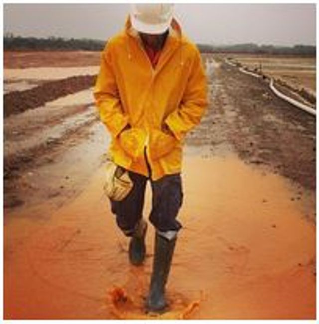 Man walking through mud