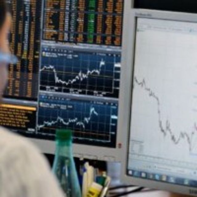 A trader checks his screens at investment bank Saxo Banque in Paris as Britain votes.