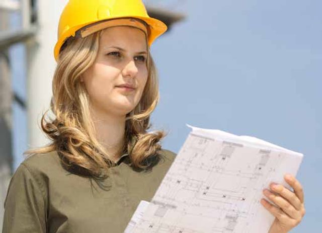 Female miner reading a plan