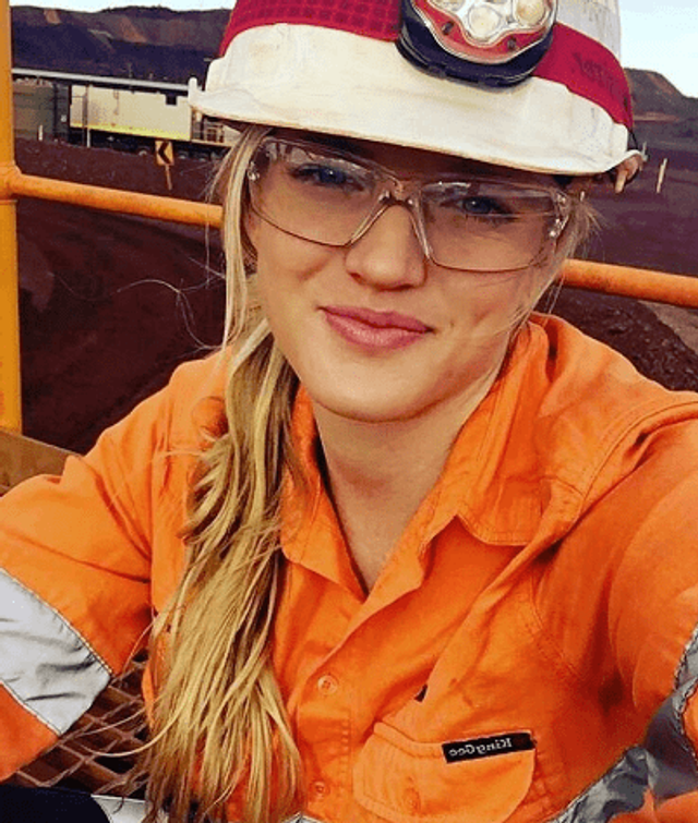 Woman wearing hi vis, safety glasses and hard hat