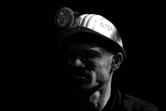 Black and white photograph of a miner