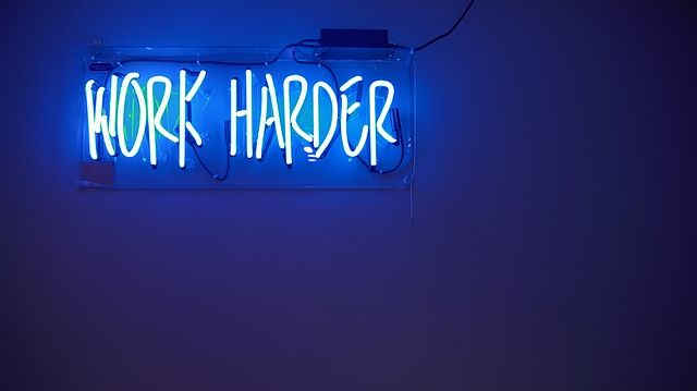 'Work Harder' neon sign