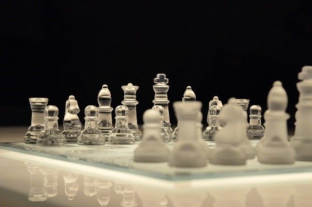 Glass chess pieces on a board