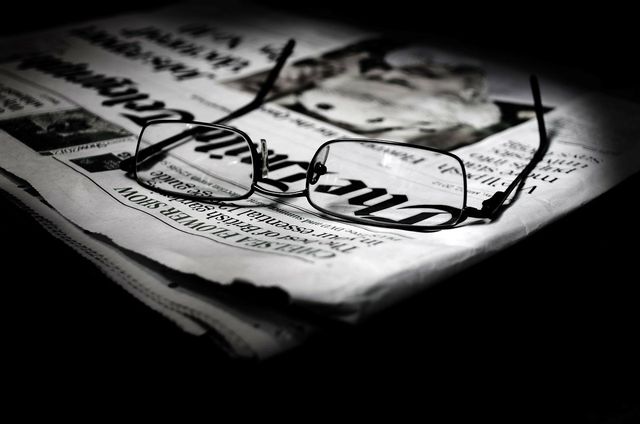 Reading glasses and a newspaper