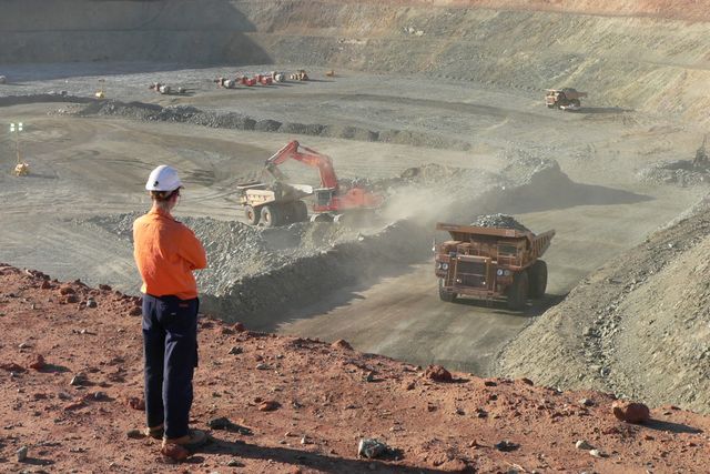 Image of person in ppe looking down at mine