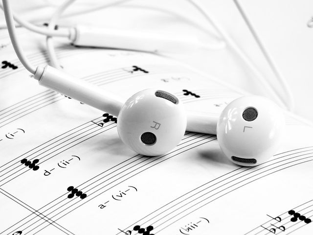 Headphones laying on sheet music