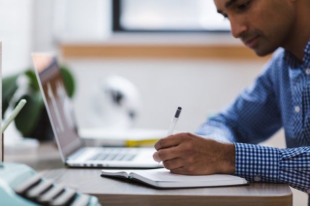 Man working on his LinkedIn profile on laptop