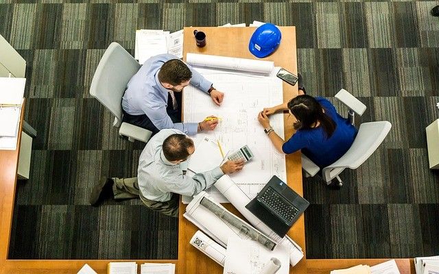 3 people around a meeting room