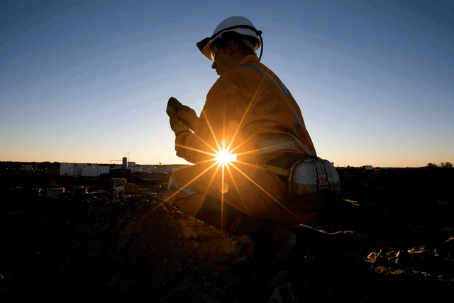 Miner with the sunlight behind them