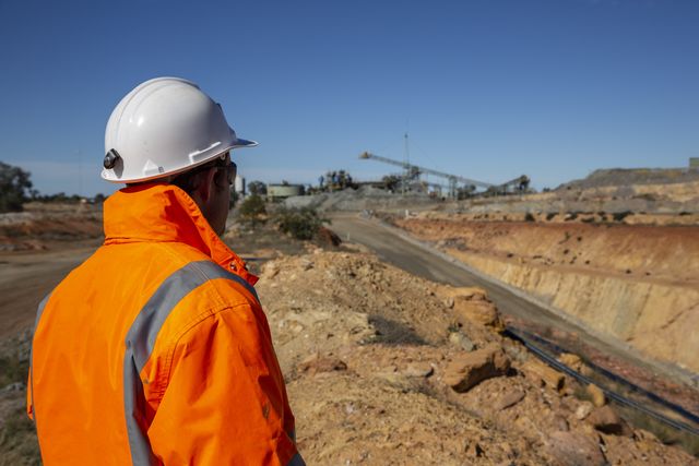 Miner looking at copper mine