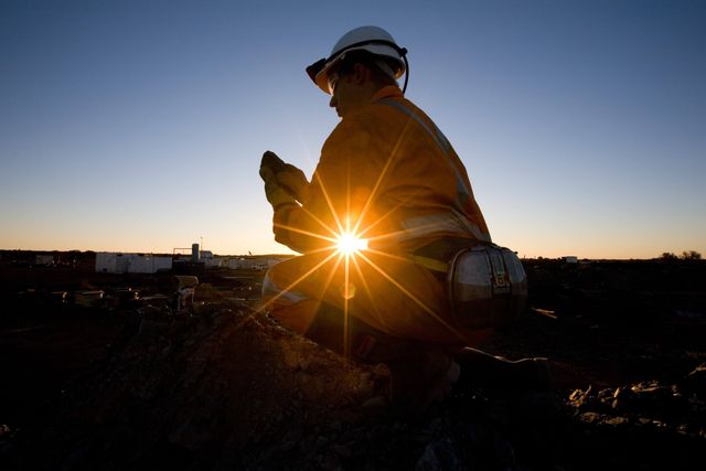 Miner sitting in the sun overlooking the camp