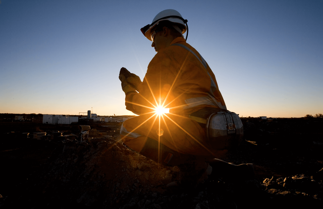 Picture of a miner sitting by sunset
