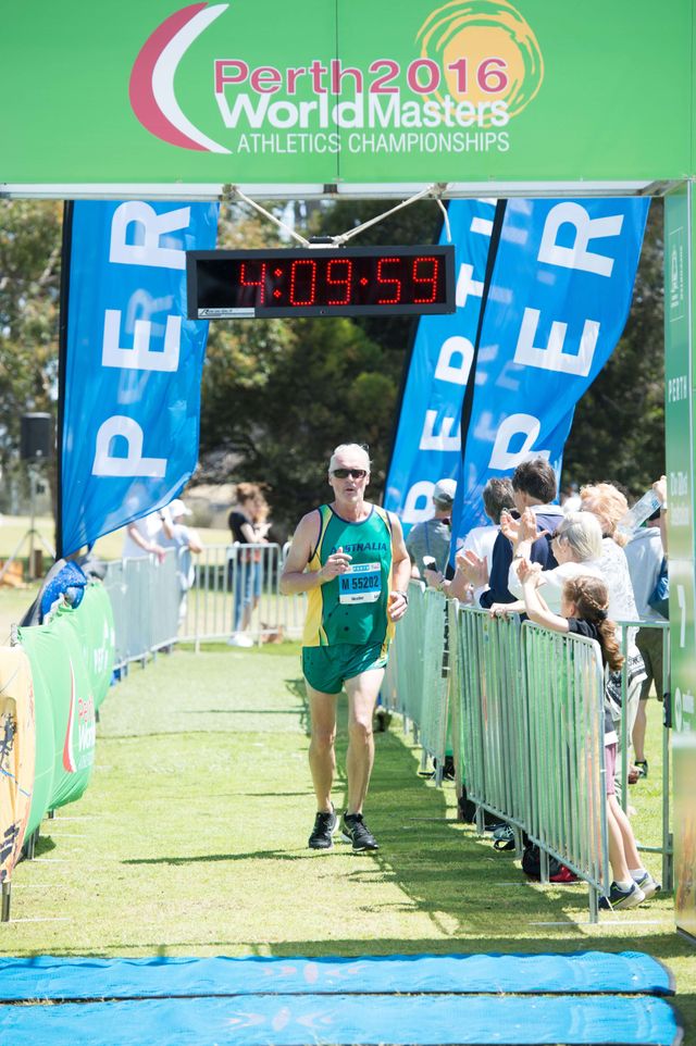 Steve Heather crossing the finish line of the Perth 2016 World Masters Marathon