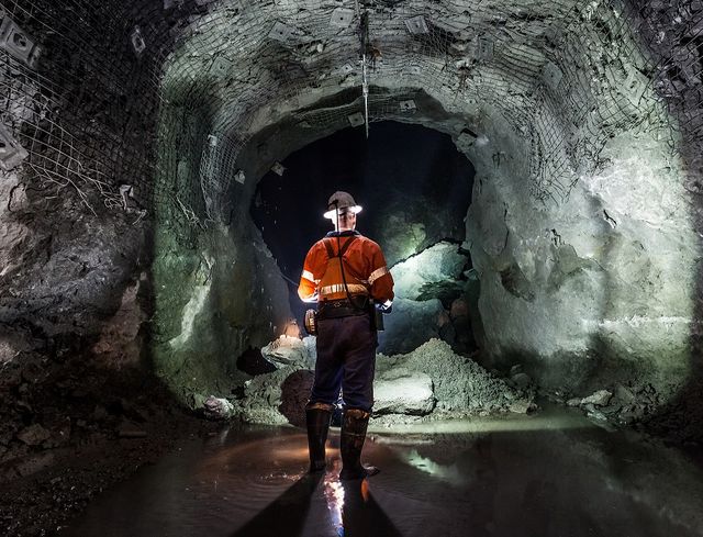 Man in underground mine with technology