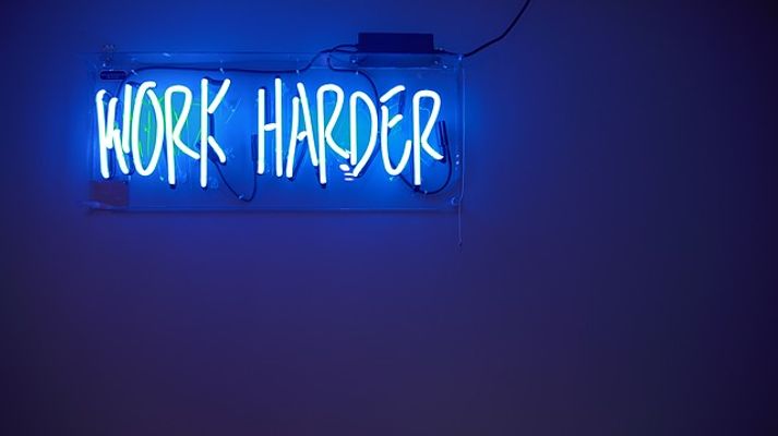 'Work Harder' neon sign