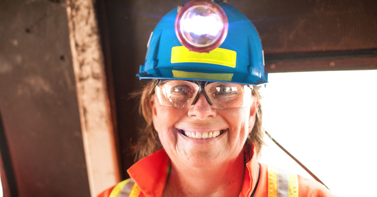 Female mine worker smiling
