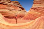 A woman walking through a canyon