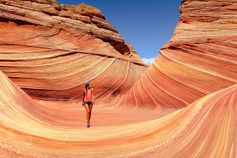 A woman walking through a canyon
