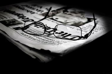 Reading glasses and a newspaper