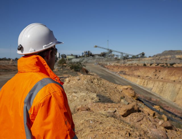 Miner looking at copper mine