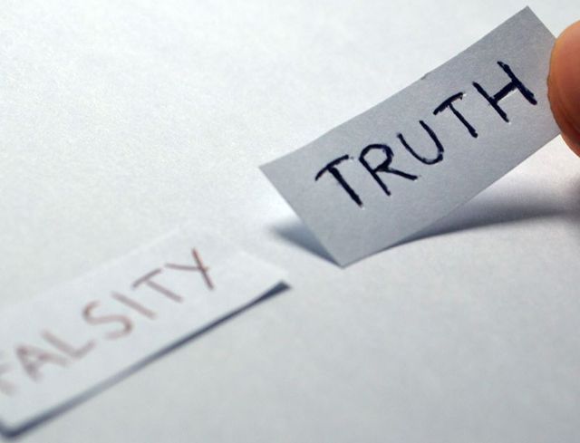'Truth' and 'Falsity' written on pieces of paper