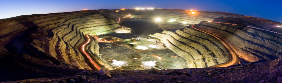 Open pit mine at night with lights on