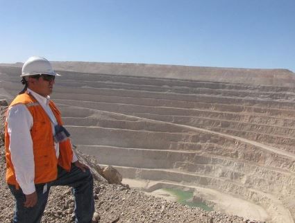 Site supervisor with helmet overlooking mine site